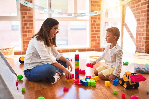 Beautiful Teacher Toddler Playing Building Blocks Lots Toys Kindergarten — Stock Photo, Image