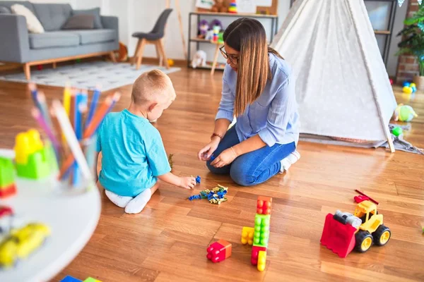 Young Caucasian Child Playing Playschool Teacher Playing Toy Soldiers Playroom — Stock Photo, Image