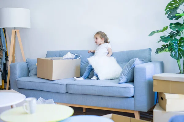 Beautiful toddler child girl jumping on the sofa