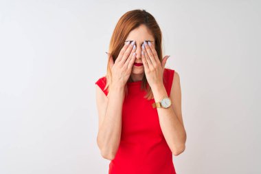 Redhead businesswoman wearing elegant red dress standing over isolated white background rubbing eyes for fatigue and headache, sleepy and tired expression. Vision problem