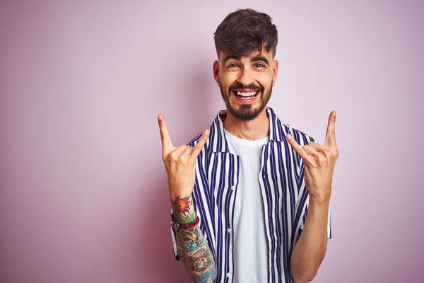 Mladý Muž Tetováním Pruhované Košili Stojící Nad Izolovaným Růžovým Pozadím — Stock fotografie