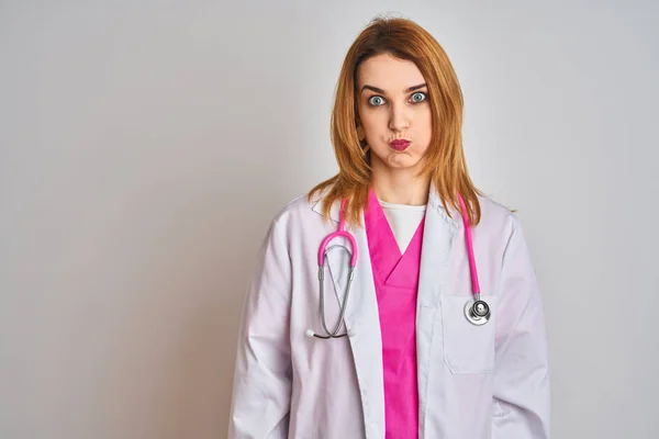 Redhead Caucasian Doctor Woman Wearing Pink Stethoscope Isolated Background Puffing — Stock Photo, Image