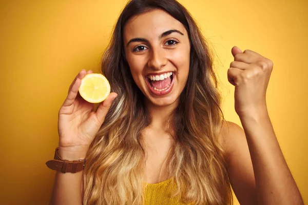 Young Beautiful Woman Holding Half Lemon Yellow Isolated Background Screaming — Stock Photo, Image