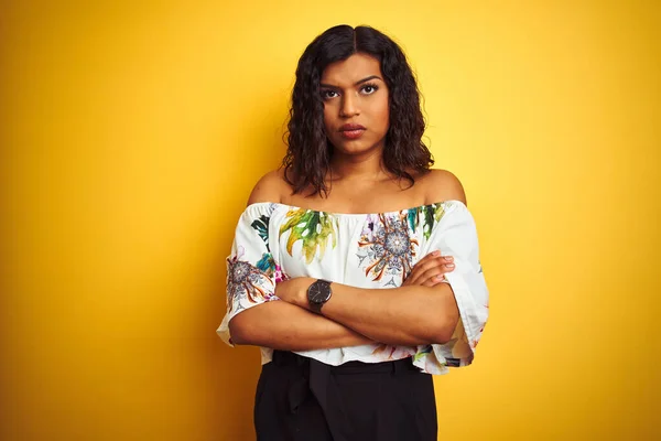 Transsexual transgender woman wearing summer t-shirt over isolated yellow background skeptic and nervous, disapproving expression on face with crossed arms. Negative person.