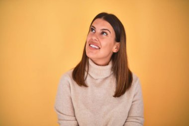 Genç, güzel bir kadın, mutlu bir şekilde gülümsüyor.