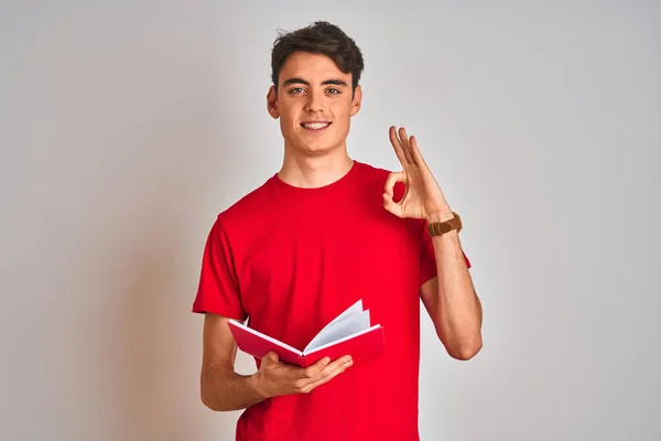 Teenager Student Boy Reading Book Isolated Background Doing Sign Fingers — ストック写真