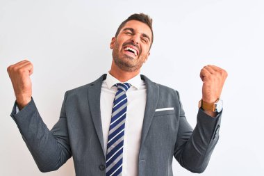 Takım elbiseli ve kravatlı genç yakışıklı iş adamı izole edilmiş arka planda gözleri kollarıyla kapayarak neşeli ve komik gülümsüyor. Kör kavram.