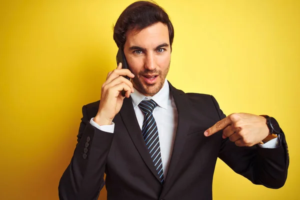 Young Handsome Businessman Talking Smartphone Isolated Yellow Background Surprise Face — Stock Photo, Image