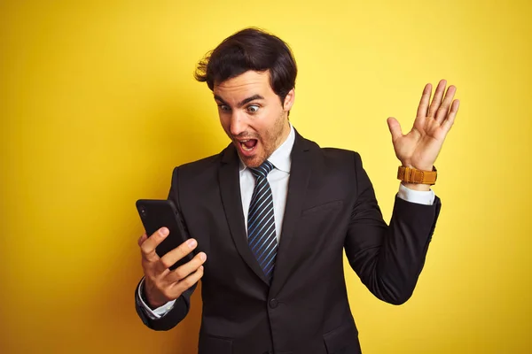 Junger Gutaussehender Geschäftsmann Mit Smartphone Der Vor Isoliertem Gelben Hintergrund — Stockfoto