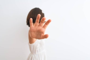 Prenses tacı takan güzel bir kız çocuğu, izole edilmiş beyaz arka planda dikiliyor ellerle gözleri örtüyor ve üzgün ve korku ifadeleriyle dur hareketi yapıyor. Utanç verici ve olumsuz bir kavram..