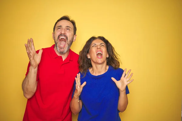 Beautiful Middle Age Couple Together Standing Isolated Yellow Background Crazy — Stock Photo, Image