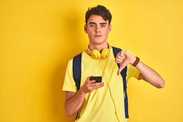 Menino Adolescente Usando Fones Ouvido Usando Smartphone Sobre Fundo Isolado — Fotografia de Stock