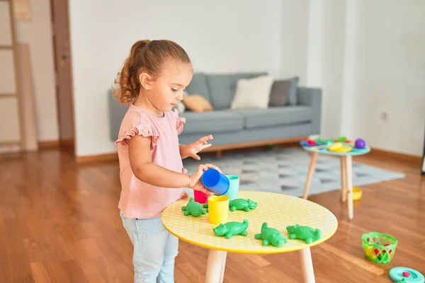 Beautiful Blond Toddler Girl Playing Plastic Frogs Toys Kindergarten — Stock Photo, Image