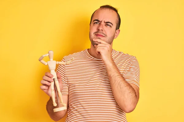 Young Man Holding Figure Art Dummy Standing Isolated Yellow Background — Stock Photo, Image