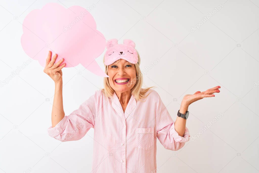 Middle age woman wearing sleep mask holding speech bubble over isolated white background very happy and excited, winner expression celebrating victory screaming with big smile and raised hands