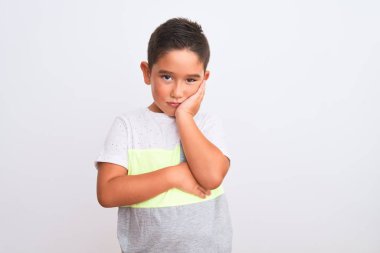 Beautiful kid boy wearing casual t-shirt standing over isolated white background thinking looking tired and bored with depression problems with crossed arms. clipart