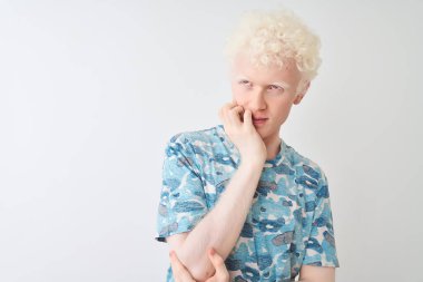 Genç albino sarışın adam, sıradan bir tişört giyiyor. İzole edilmiş beyaz arka plan üzerinde duruyor. Kollarını kavuşturup depresyondan sıkılmış ve yorgun görünüyor..