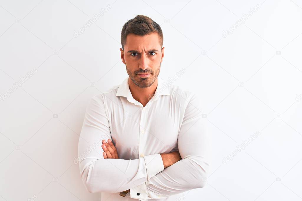 Young handsome business man wearing elegant shirt over isolated background skeptic and nervous, disapproving expression on face with crossed arms. Negative person.