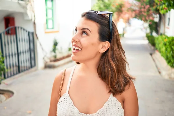 Young beautiful woman at the colorful village of Puerto de Mogan, smiling happy at the street on summer holidays