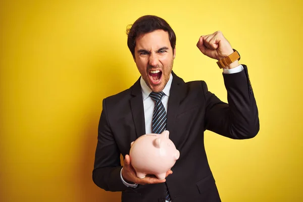 Young Handsome Businessman Holding Piggy Bank Isolated Yellow Background Annoyed — Stock Photo, Image