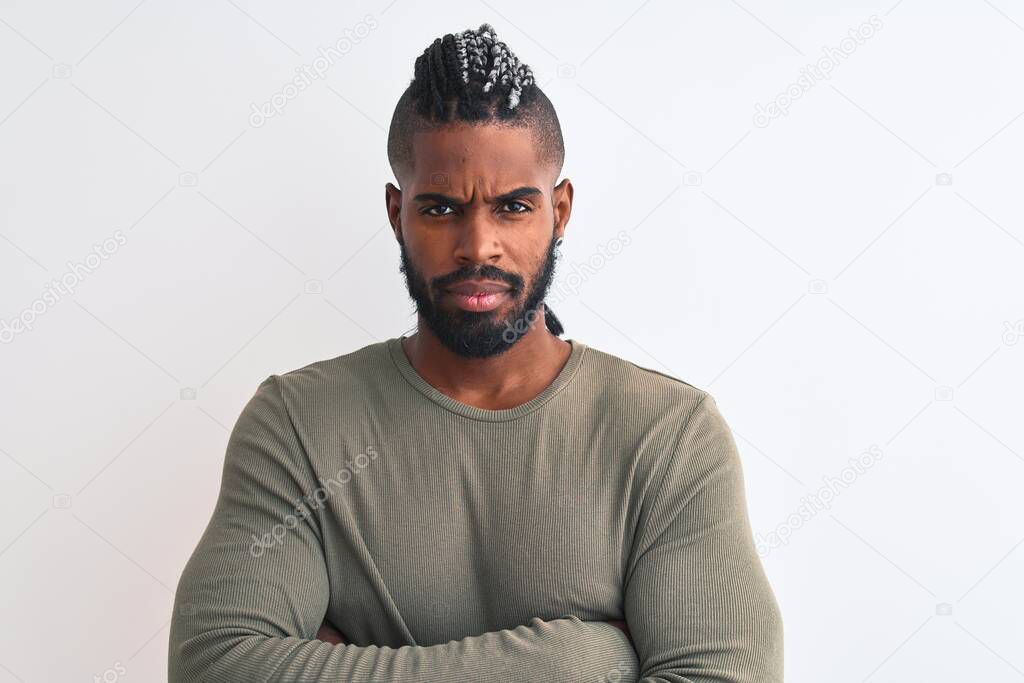 African american man with braids wearing green sweater over isolated white background skeptic and nervous, disapproving expression on face with crossed arms. Negative person.