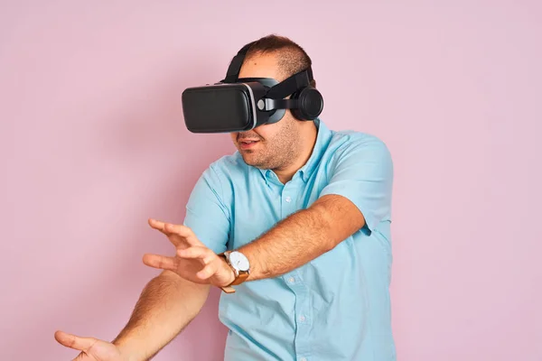 Young plus size man playing virtual reality game using goggles