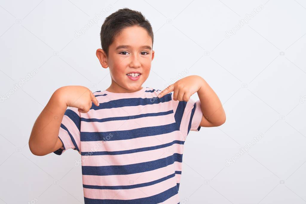 Beautiful kid boy wearing casual striped t-shirt standing over isolated white background looking confident with smile on face, pointing oneself with fingers proud and happy.