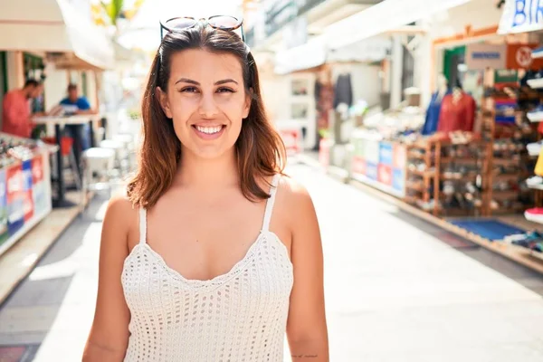 Young beautiful woman at the colorful village of Puerto de Mogan, smiling happy at the street on summer holidays