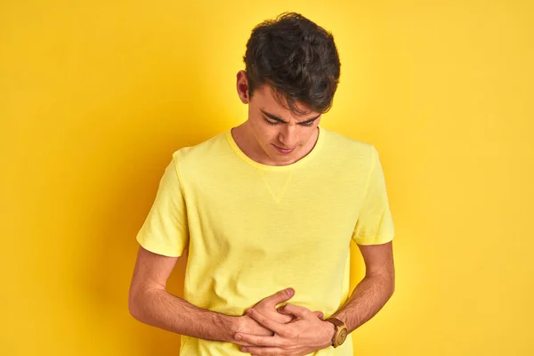 Teenager Boy Wearing Yellow Shirt Isolated Background Hand Stomach Because — 스톡 사진
