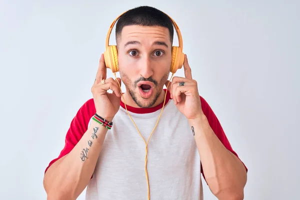 Young Handsome Man Wearing Headphones Isolated Background Scared Shock Surprise — 스톡 사진