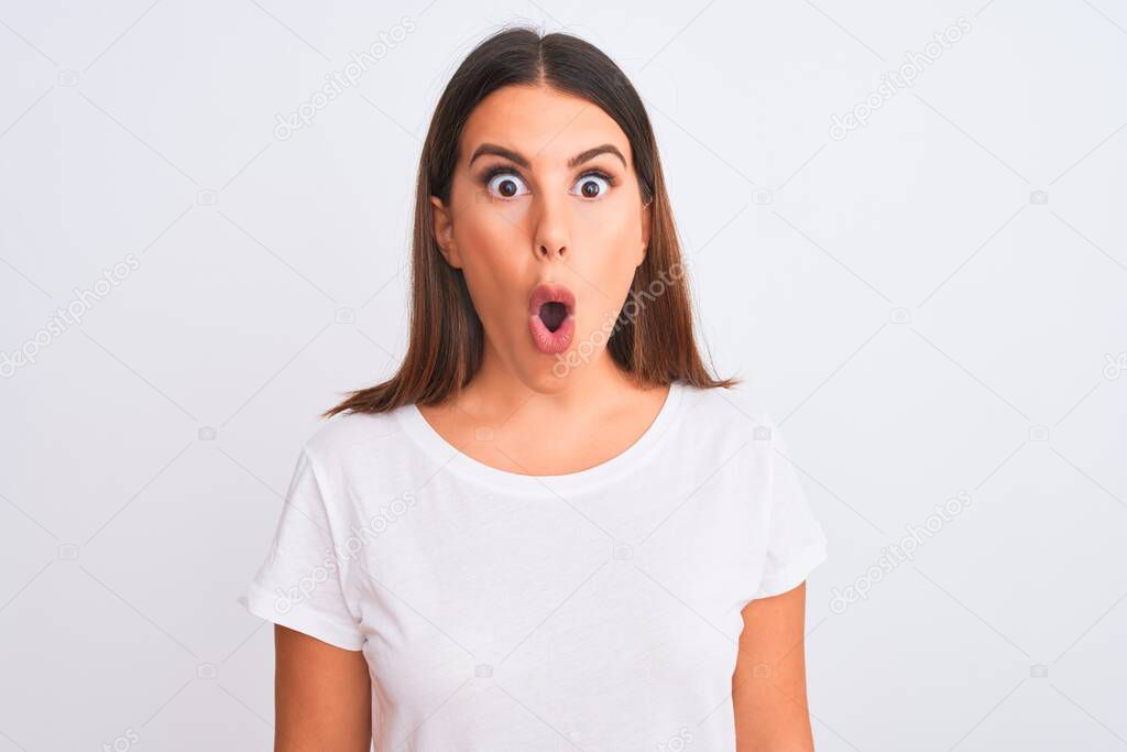 Portrait of beautiful and young brunette woman standing over isolated white background afraid and shocked with surprise expression, fear and excited face.