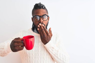African american man with braids drinking cup of coffee over isolated white background cover mouth with hand shocked with shame for mistake, expression of fear, scared in silence, secret concept