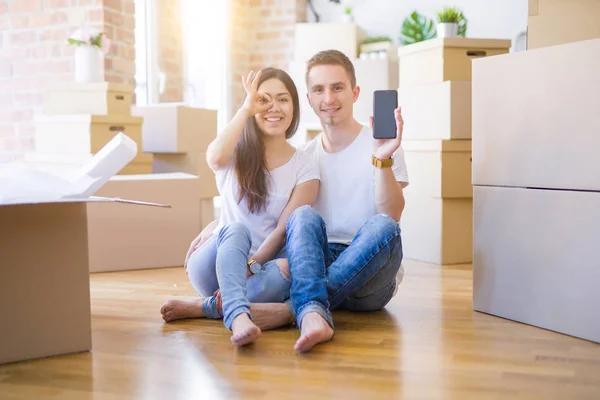 Beautiful Couple Sitting Floor Holding Smartphone New Home Cardboard Boxes — 스톡 사진