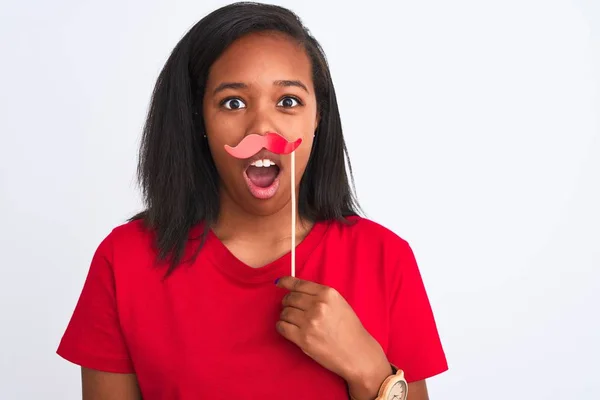 Young african american woman wearing vintage pretend mustache over isolated background scared in shock with a surprise face, afraid and excited with fear expression