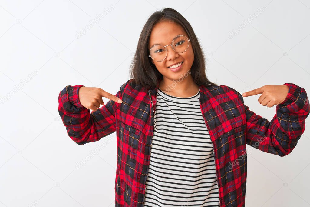 Young chinese woman wearing t-shirt jacket and glasses over isolated white background looking confident with smile on face, pointing oneself with fingers proud and happy.