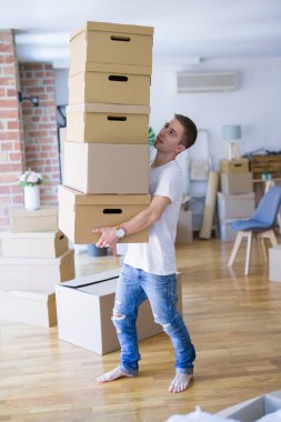 man carrying many boxes