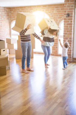 Yeni evde karton bel kutuları ile oynayan çocuk ile güzel famiily