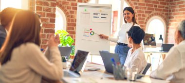 Group of business workers working together in a meeting. One of them making presentation to colleagues at the office