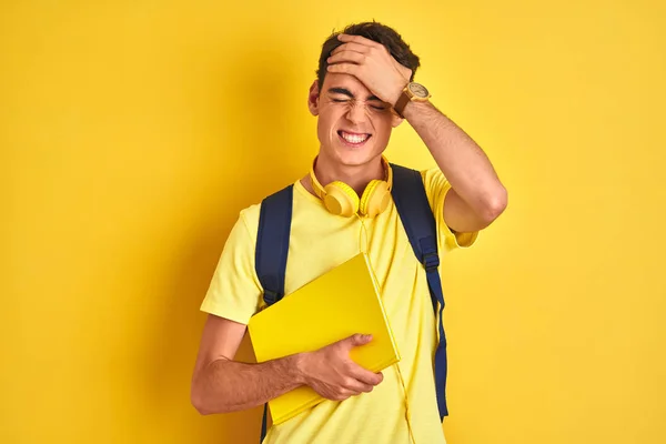 Teenager Boy Wearing Headphones Backpack Reading Book Isolated Background Stressed — 图库照片