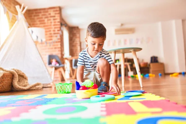 Schöner Kleinkind Junge Sitzt Auf Puzzle Spielen Mahlzeiten Mit Plastiktellern — Stockfoto