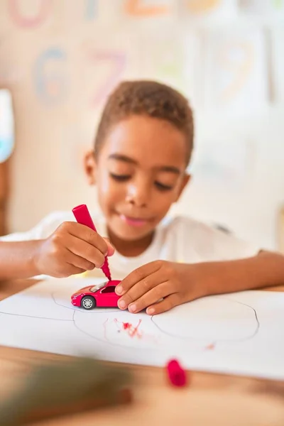 Beautiful African American Toddler Sitting Painting Car Toy Using Marker — ストック写真