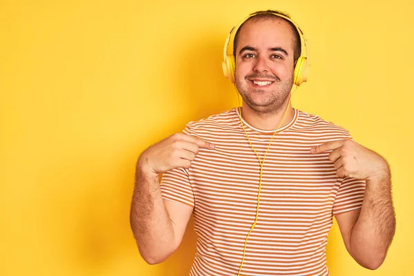 Young Man Listening Music Using Headphones Standing Isolated Yellow Background — 스톡 사진