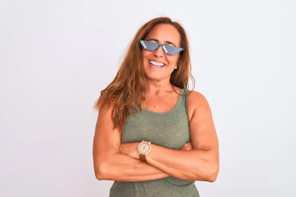 Middle age mature woman wearing thug life sunglasses over isolated background happy face smiling with crossed arms looking at the camera. Positive person.