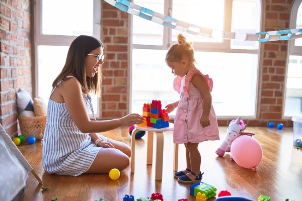 Young Beautiful Teacher Toddler Playing Building Blocks Toy Table Kindergarten — Stock Photo, Image