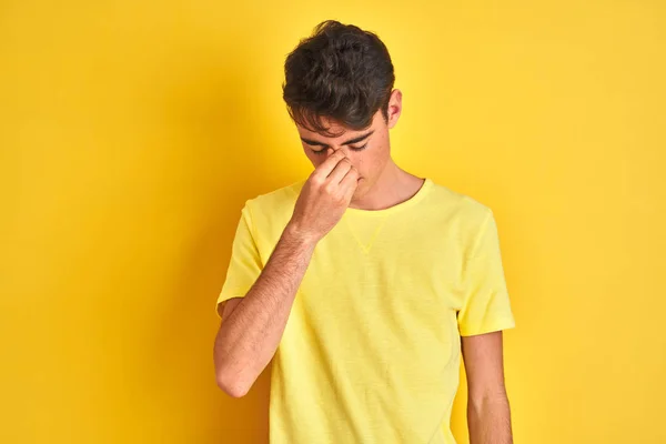 Teenager Boy Wearing Yellow Shirt Isolated Background Tired Rubbing Nose — ストック写真