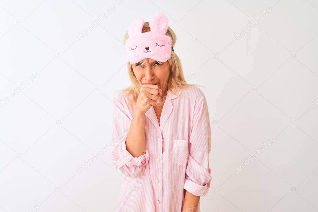 Middle age woman wearing sleep mask and pajama over isolated white background feeling unwell and coughing as symptom for cold or bronchitis. Healthcare concept.