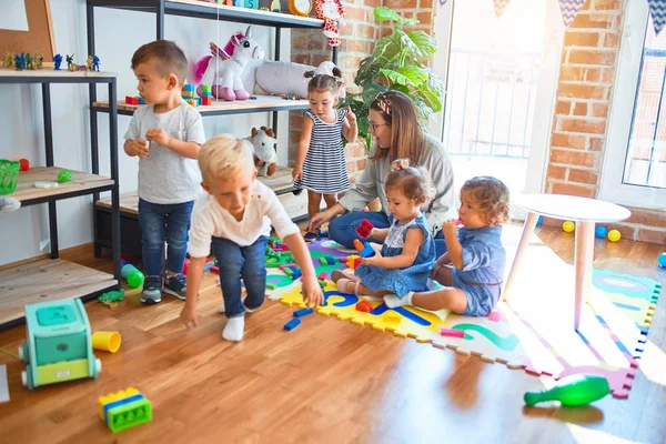 Vacker Lärare Och Grupp Småbarn Leker Runt Massor Leksaker Dagis — Stockfoto