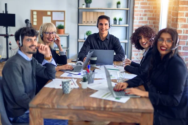 Group of call center workers smiling happy and confident. Working together with smile on face using headset at the office.