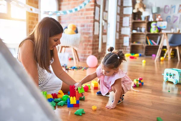 Young Beautiful Teacher Toddler Sitting Floor Playing Building Blocks Toy — Stock Photo, Image