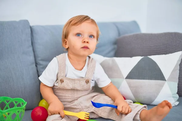 Entzückendes Blondes Kleinkind Sitzt Auf Dem Sofa Und Spielt Hause — Stockfoto